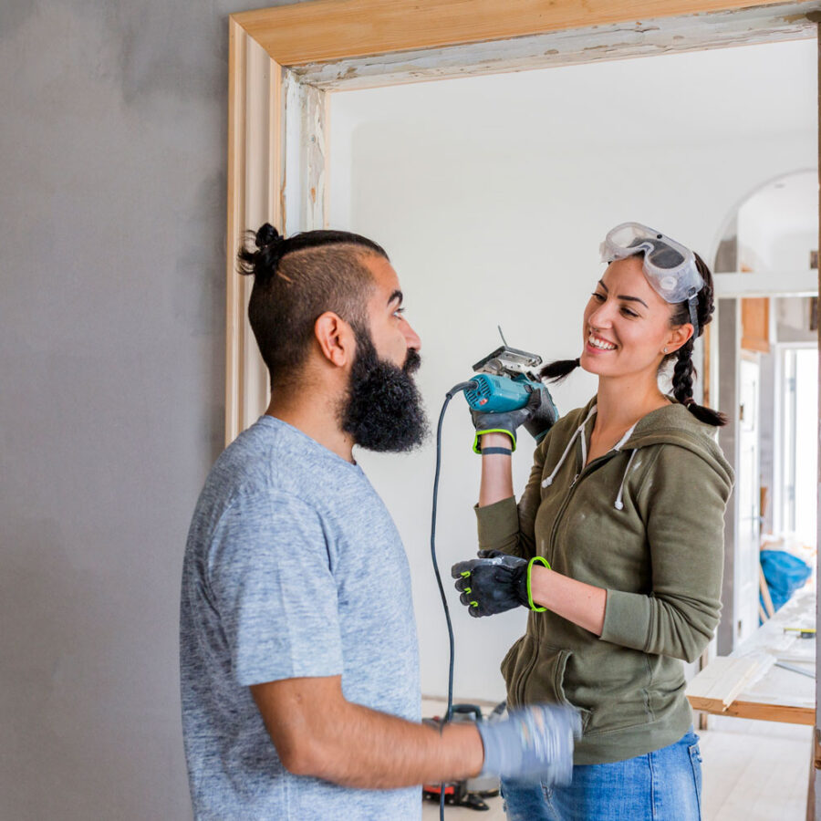Couple talking while doing home improvements for finances.